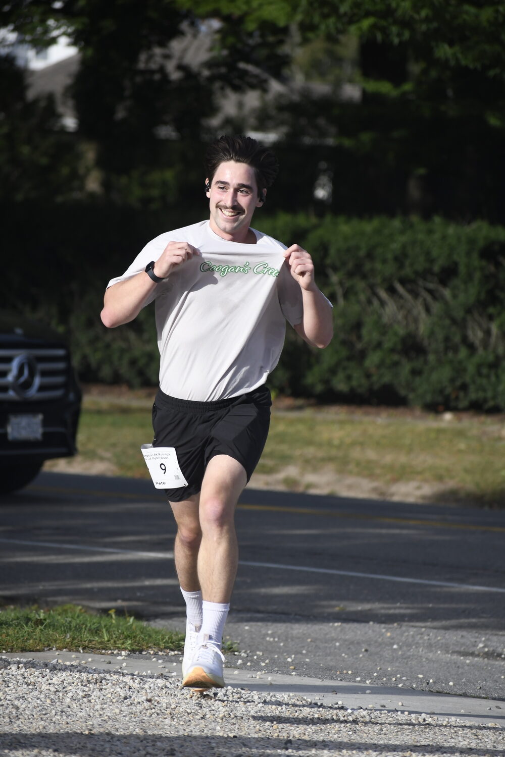 Nephew of Peter and Suzanne Walsh who placed second overall holds up his T-shirt 