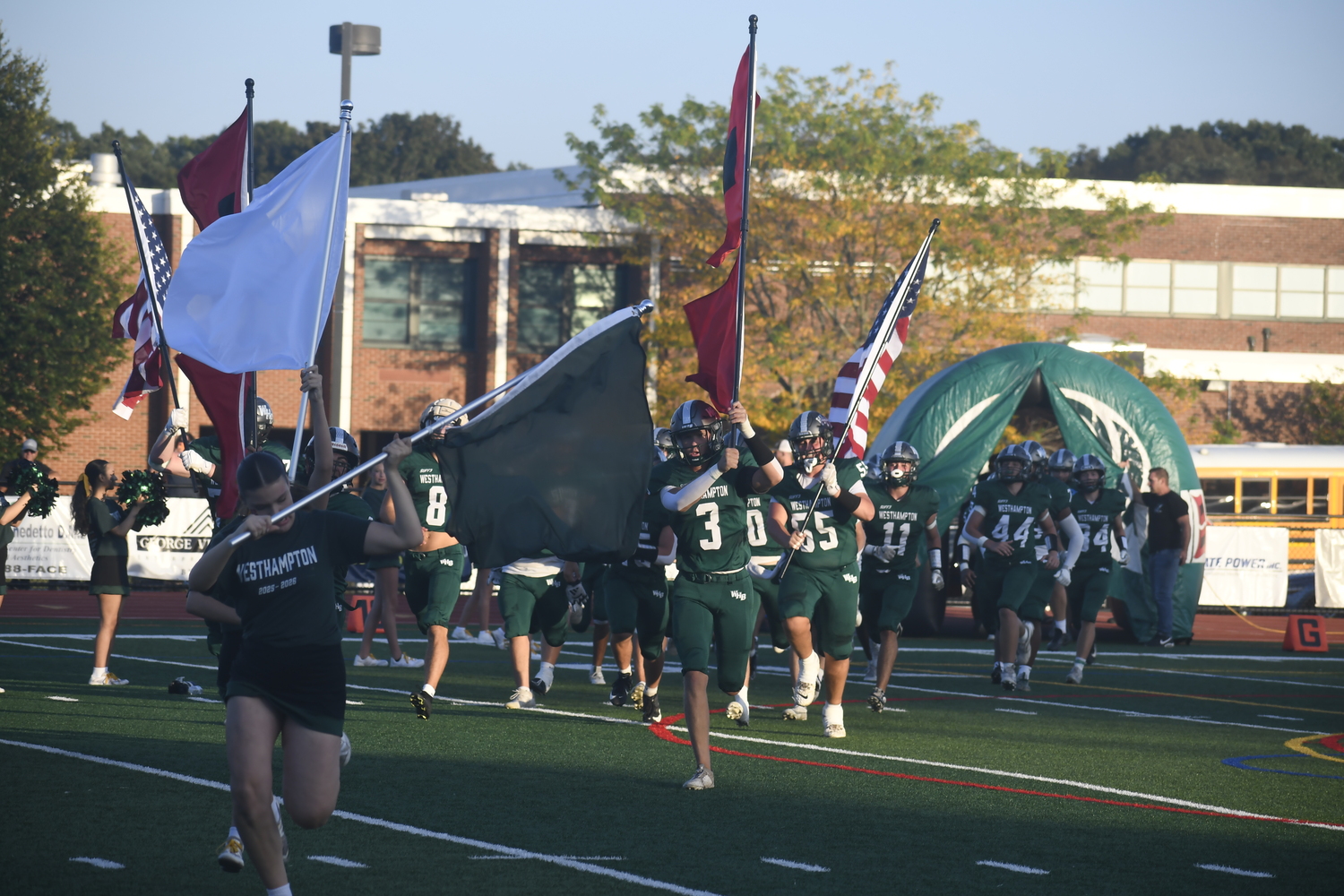 Senior Derrick Hansen leads the Hurricanes onto the field to get their game with crosstown rival Eastport-South Manor underway.  DREW BUDD
