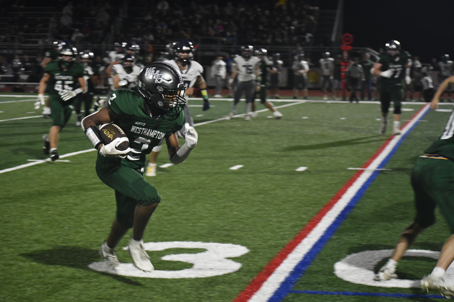 Kyle Coffey has some room to run behind a block from Nate LoGelfo.  DREW BUDD