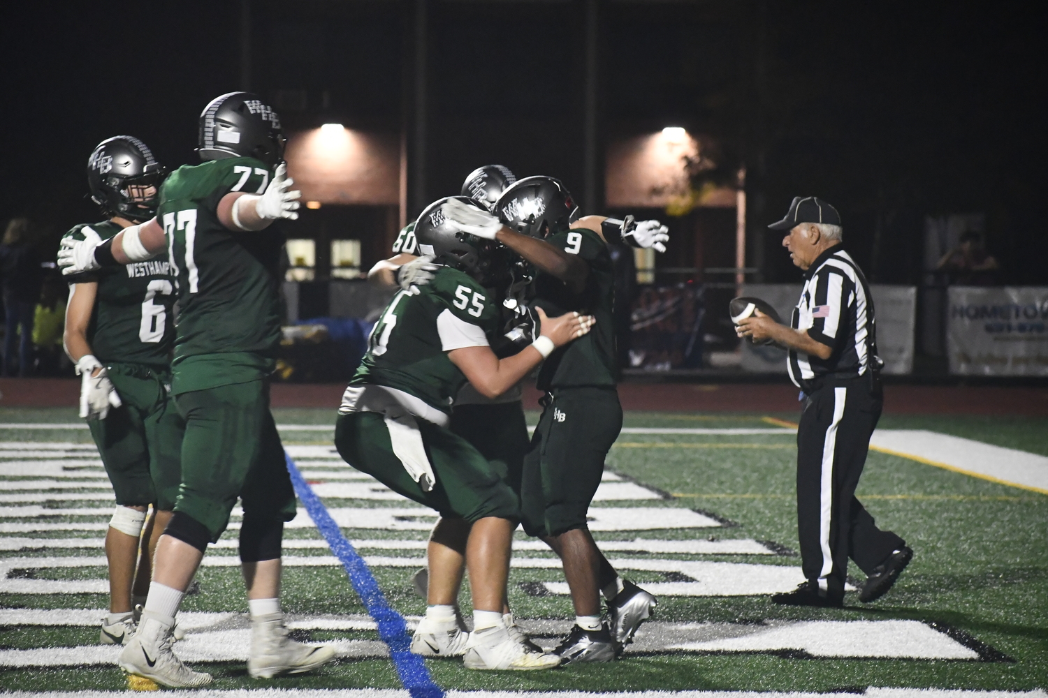 Nic Simone is greeted by teammates after his fourth touchdown on the night.  DREW BUDD