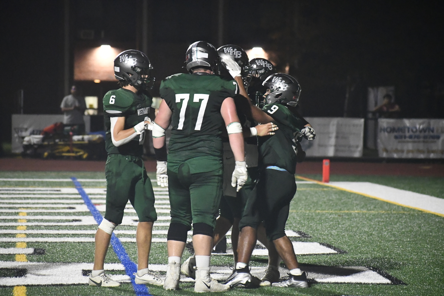 Nic Simone is greeted by teammates after his fourth touchdown on the night.  DREW BUDD