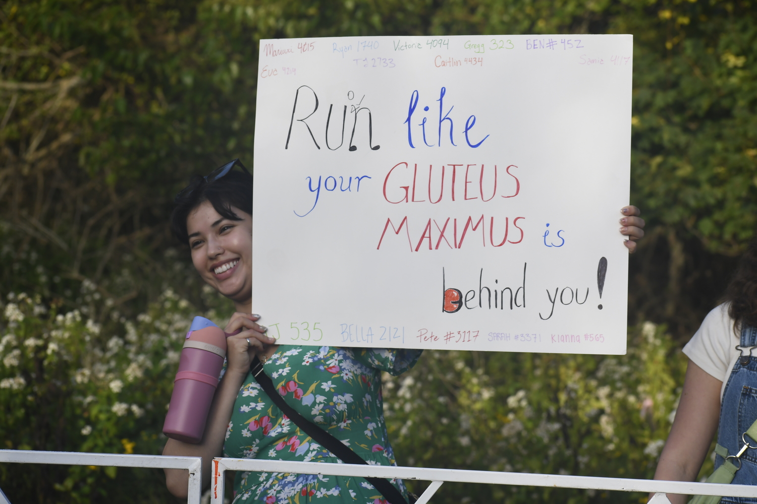 A fan holds up a sign.  DREW BUDD