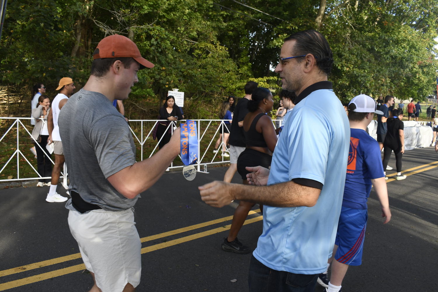 Volunteers hand out medals.  DREW BUDD