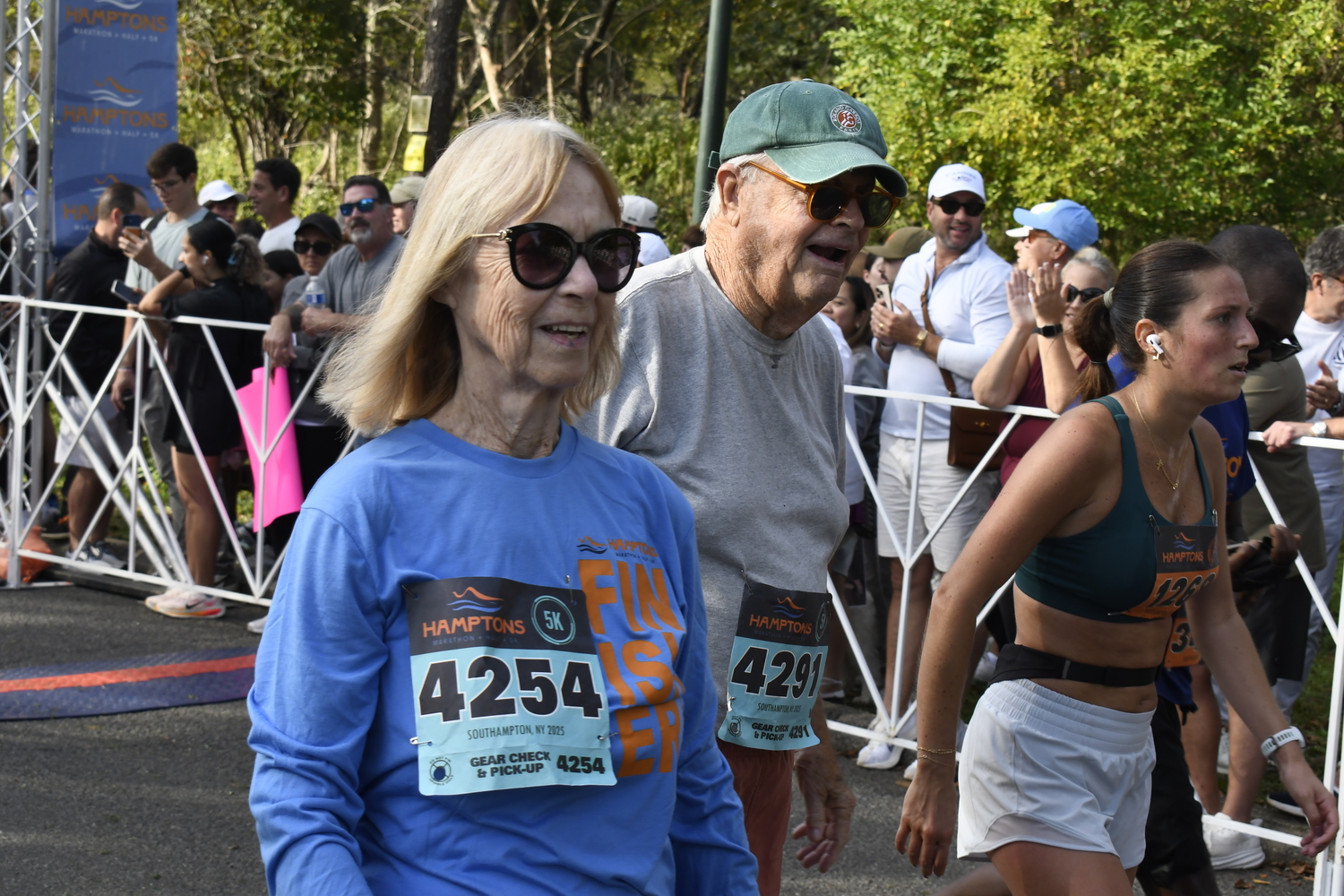Margaret Ginty, 85, and Robert Janson, 86, cross the finish line in the 5K.  DREW BUDD