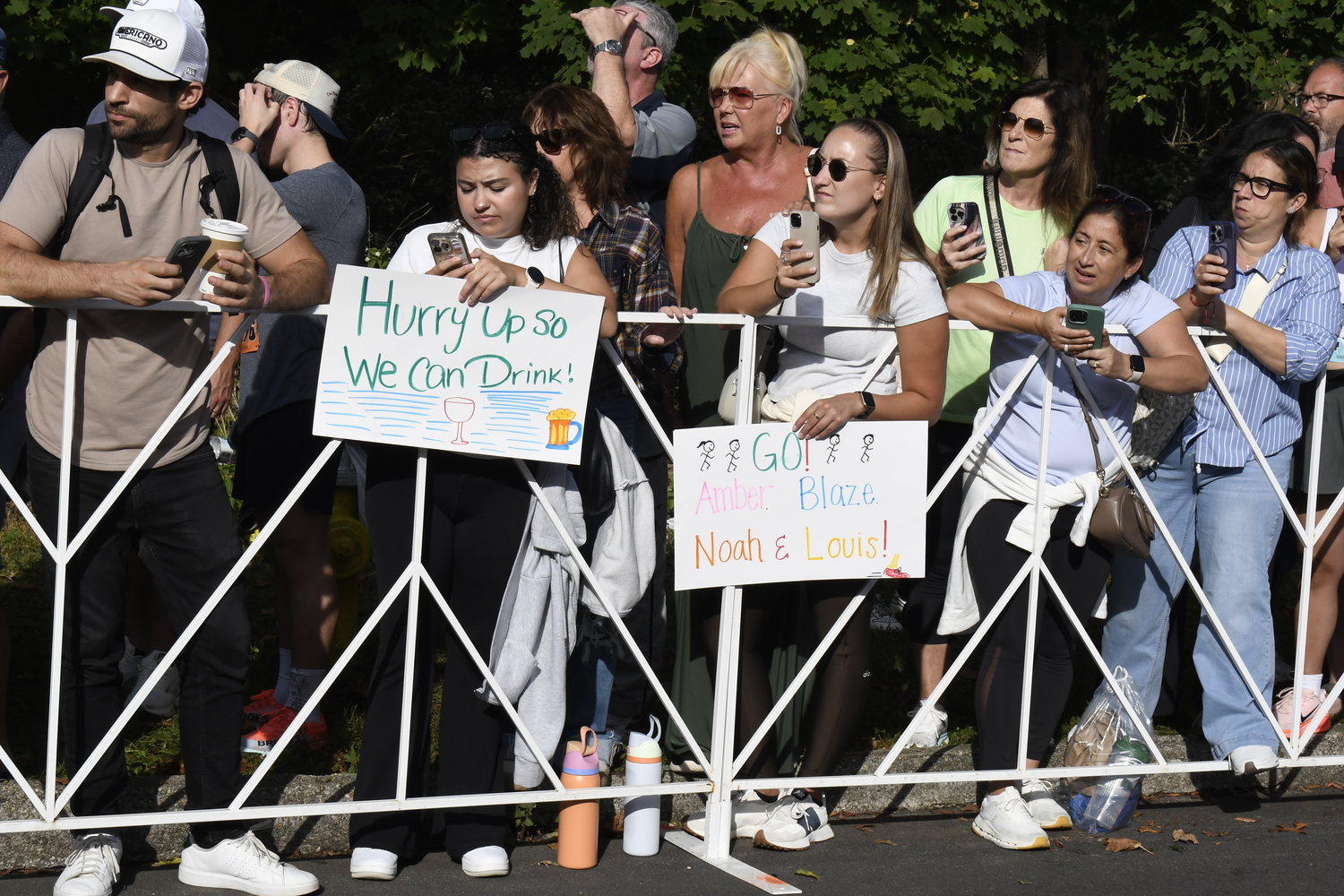 Fans await their friends and family to cross the finish line.  DREW BUDD