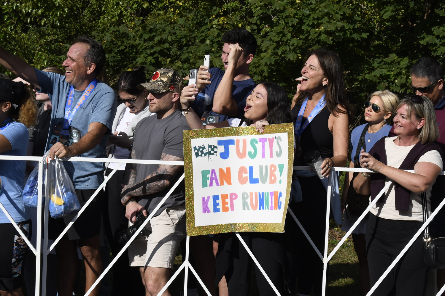 Fans await their friends and family to cross the finish line.  DREW BUDD