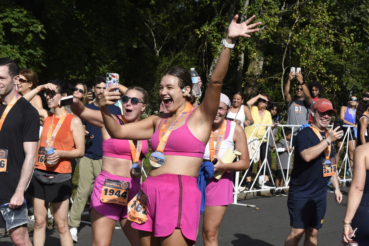 Friends cheer on each other at the finish line.  DREW BUDD