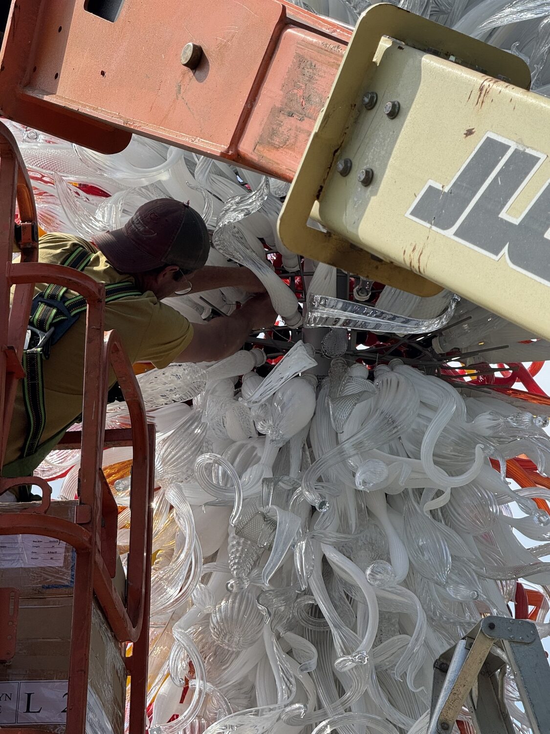 Christopher Pfeifle installs the Children's Holocaust Memorial Tower, created by Dale Chihuly, at the Hampton Synagogue in Westhampton Beach. COURTESY CHRISTOPHER PFEIFLE