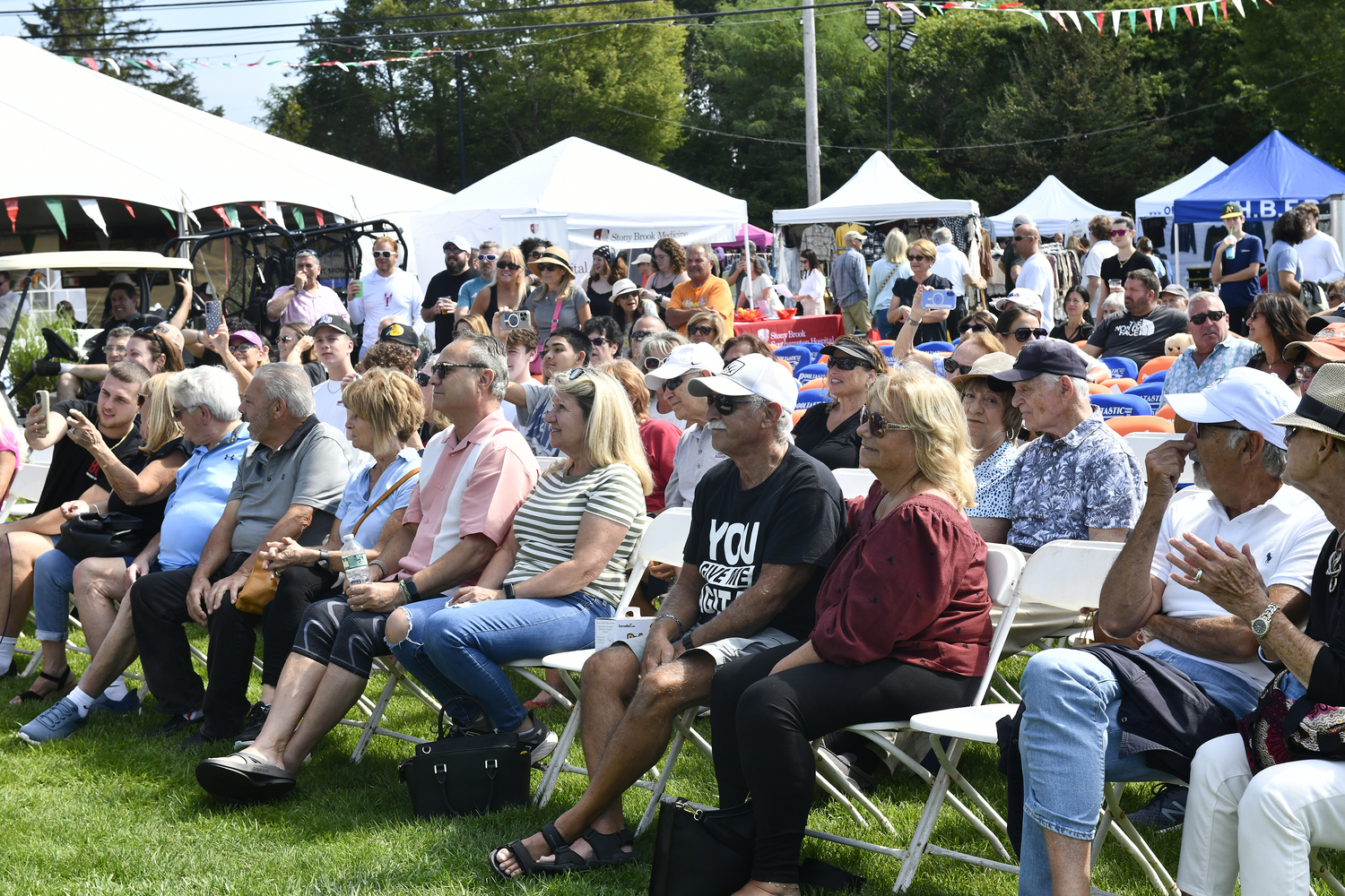 the crowd watches the cannoli eating contest at the San Gennaro Feast of the Hamptons on Saturday.