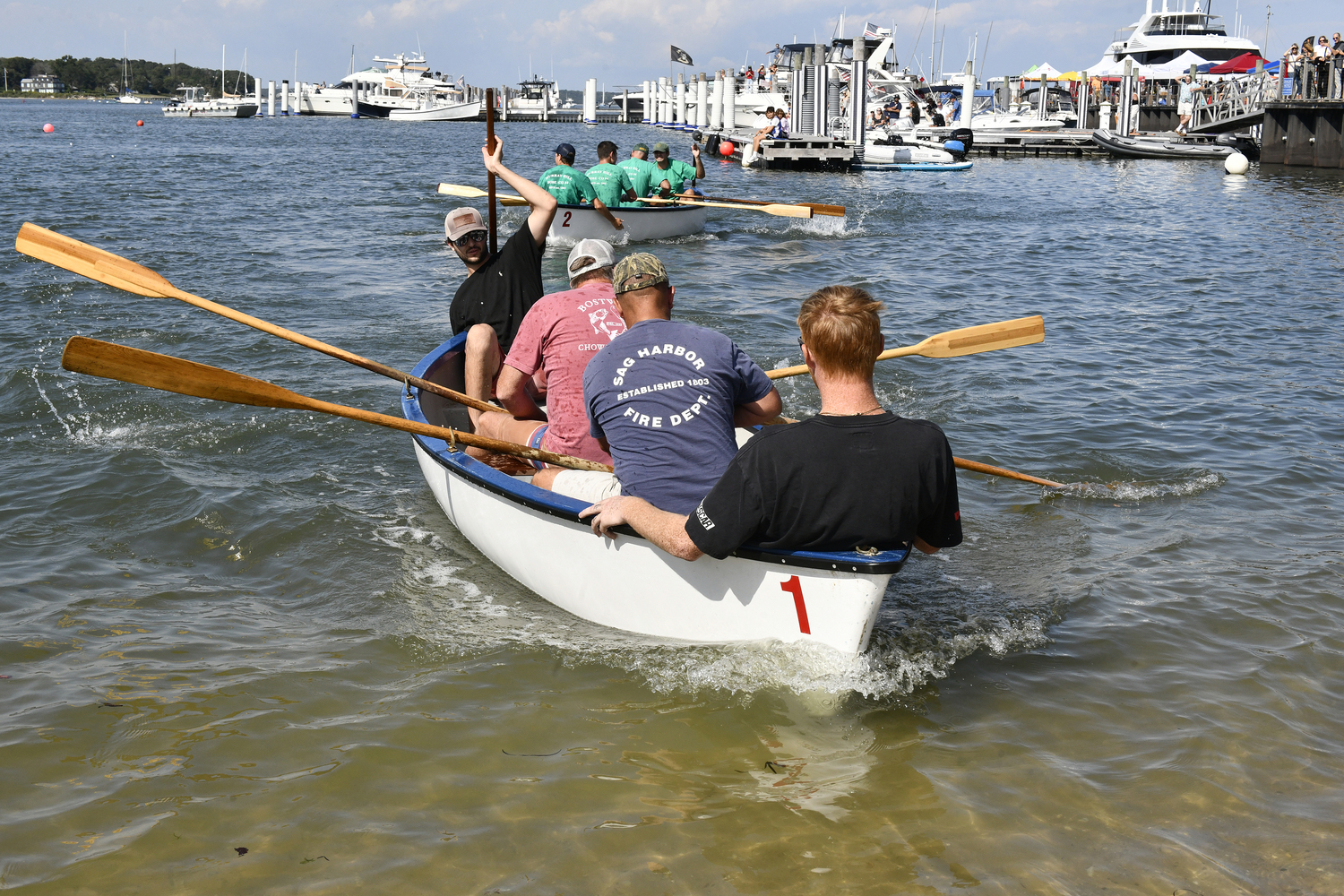 The Sag Harbor Dive Team takes the Firefighters' Cup in the Whaleboat Races on Sunday at HarborFest.  DANA SHAW