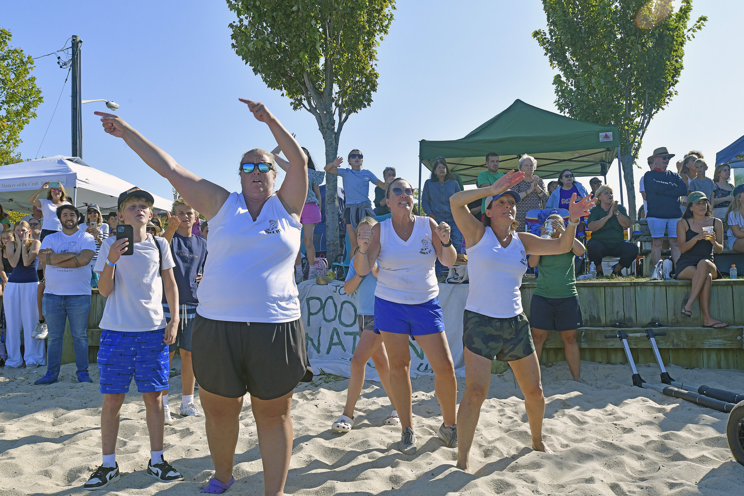 The John K. Ott women's whaleboat team cheers on the men's team at HaborFest 2024.  DANA SHAW