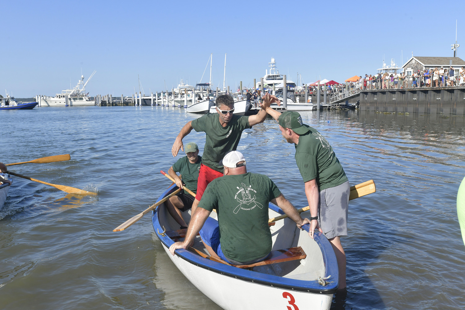 The John K. Ott men's whaleboat team take the trophy at HarborFrost 2024.  DANA SHAW