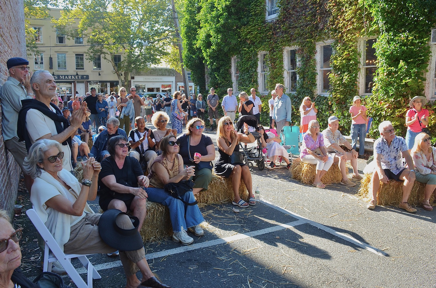 The crowd listens to New Moon Acoustic Blues on the Alley Stage on Sunday.  KYRIL BROMLEY