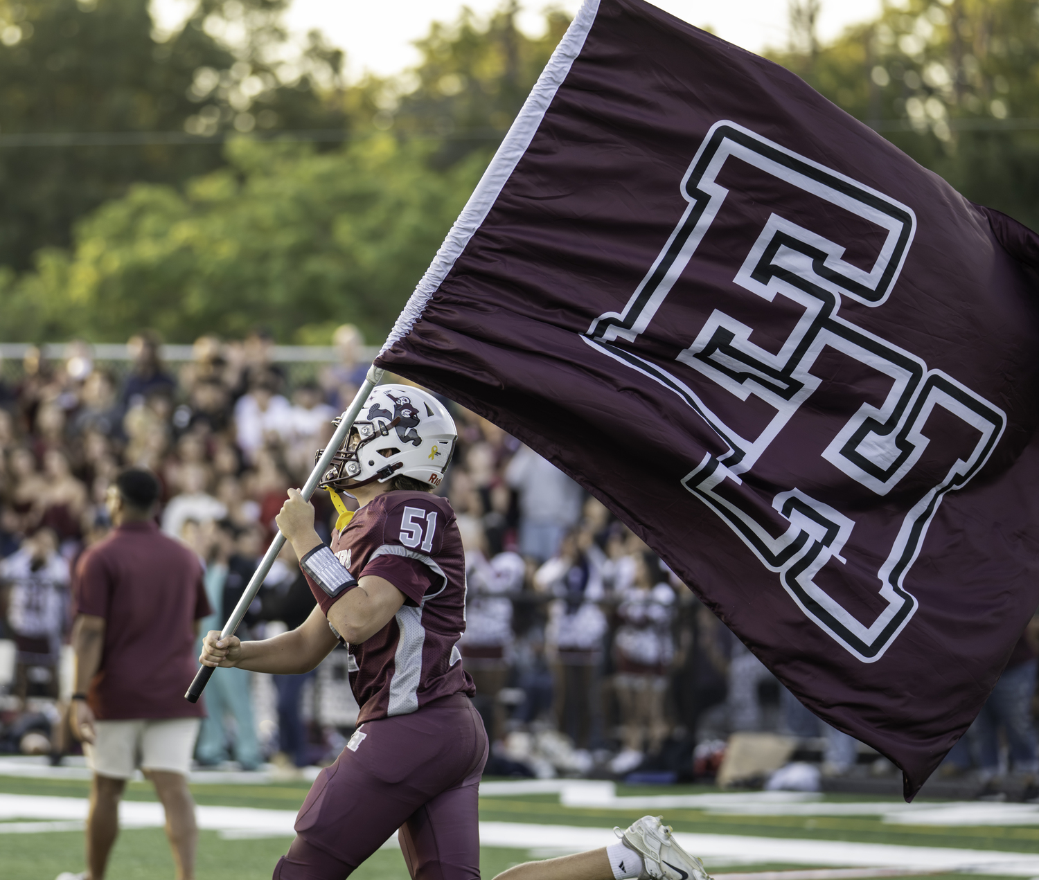 East Hampton senior James Corwin leads the Bonackers onto the field on Friday. MARIANNE BARNETT