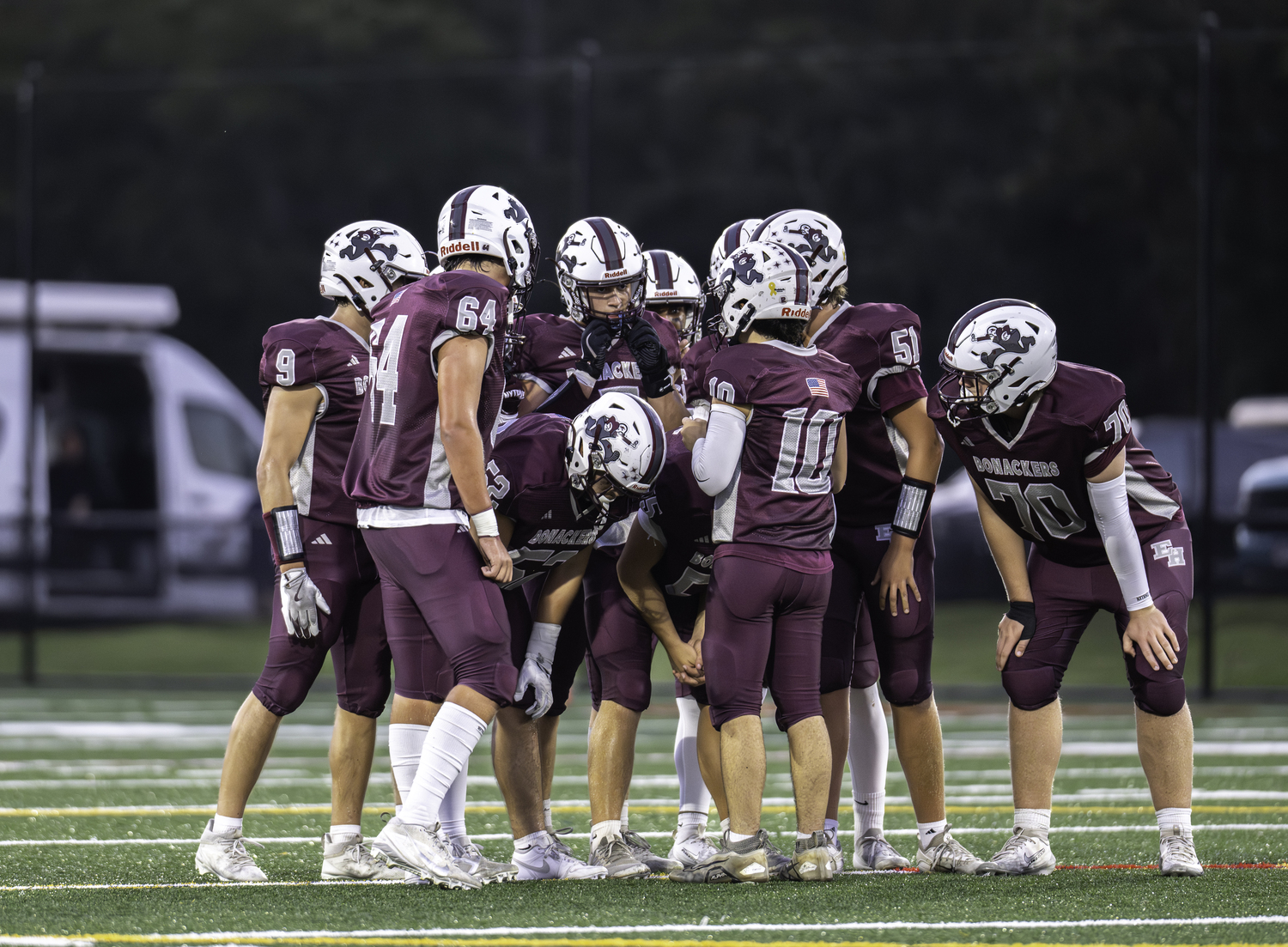 Bonac quarterback Theo Ball gets the offense set in the huddle.  MARIANNE BARNETT