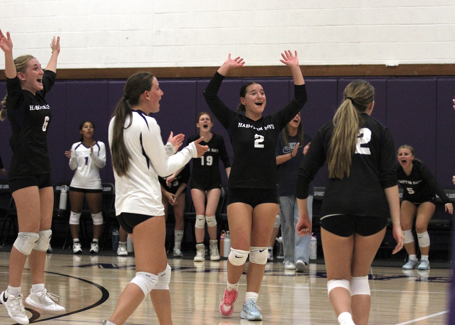 Senior outside hitter Madysen Frederiksen celebrates a fourth-set win with teammates Lily Billingham, Lilly Maffia, and Grace Drake. DESIRÉE KEEGAN