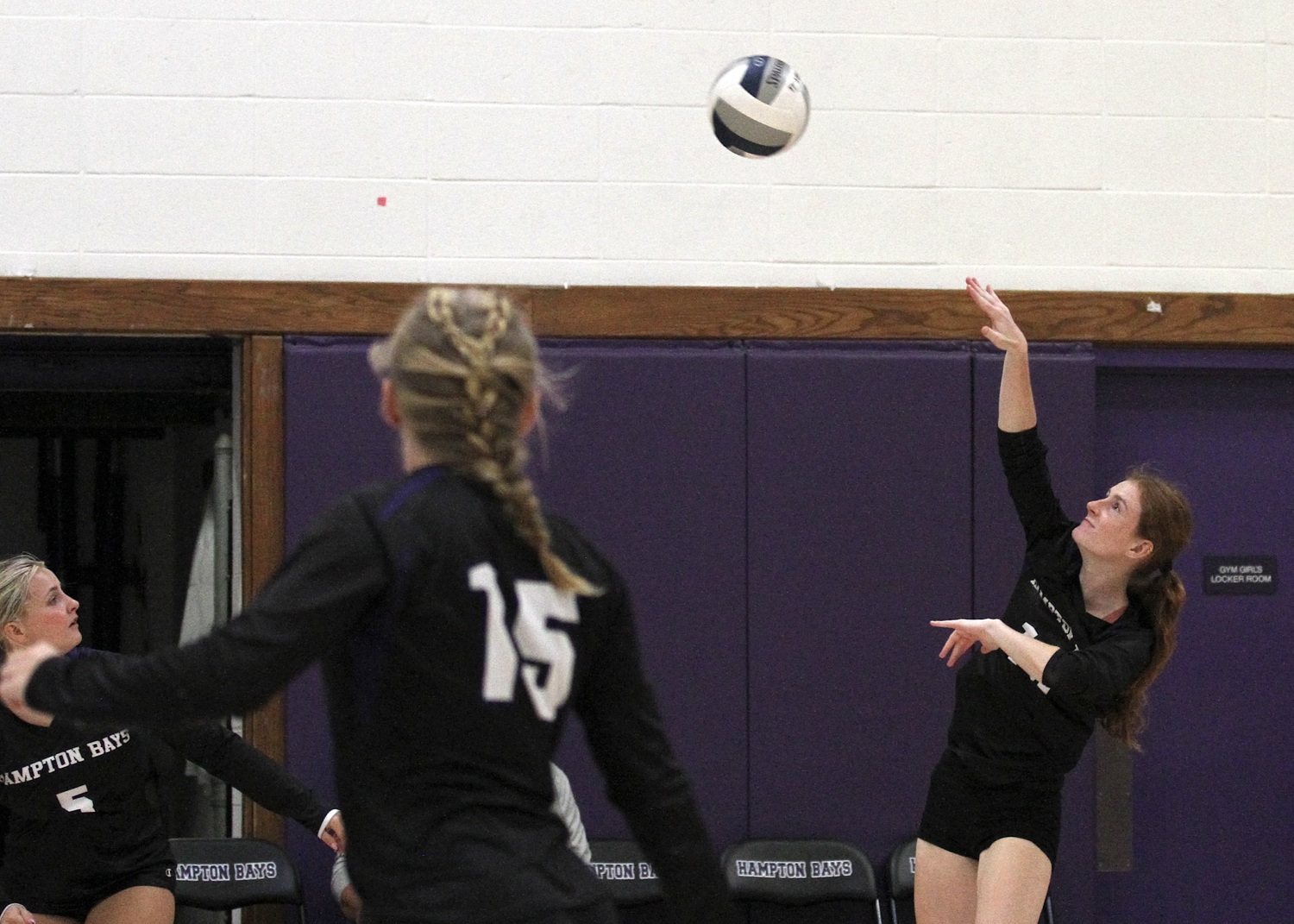 Senior middle blocker Shea Egan hits the ball over the net. DESIRÉE KEEGAN