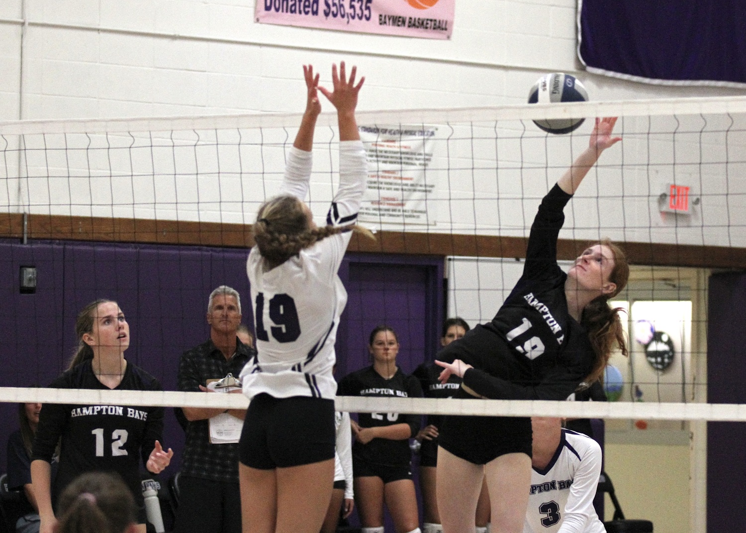 Senior middle blocker Shea Egan hits the ball. DESIRÉE KEEGAN