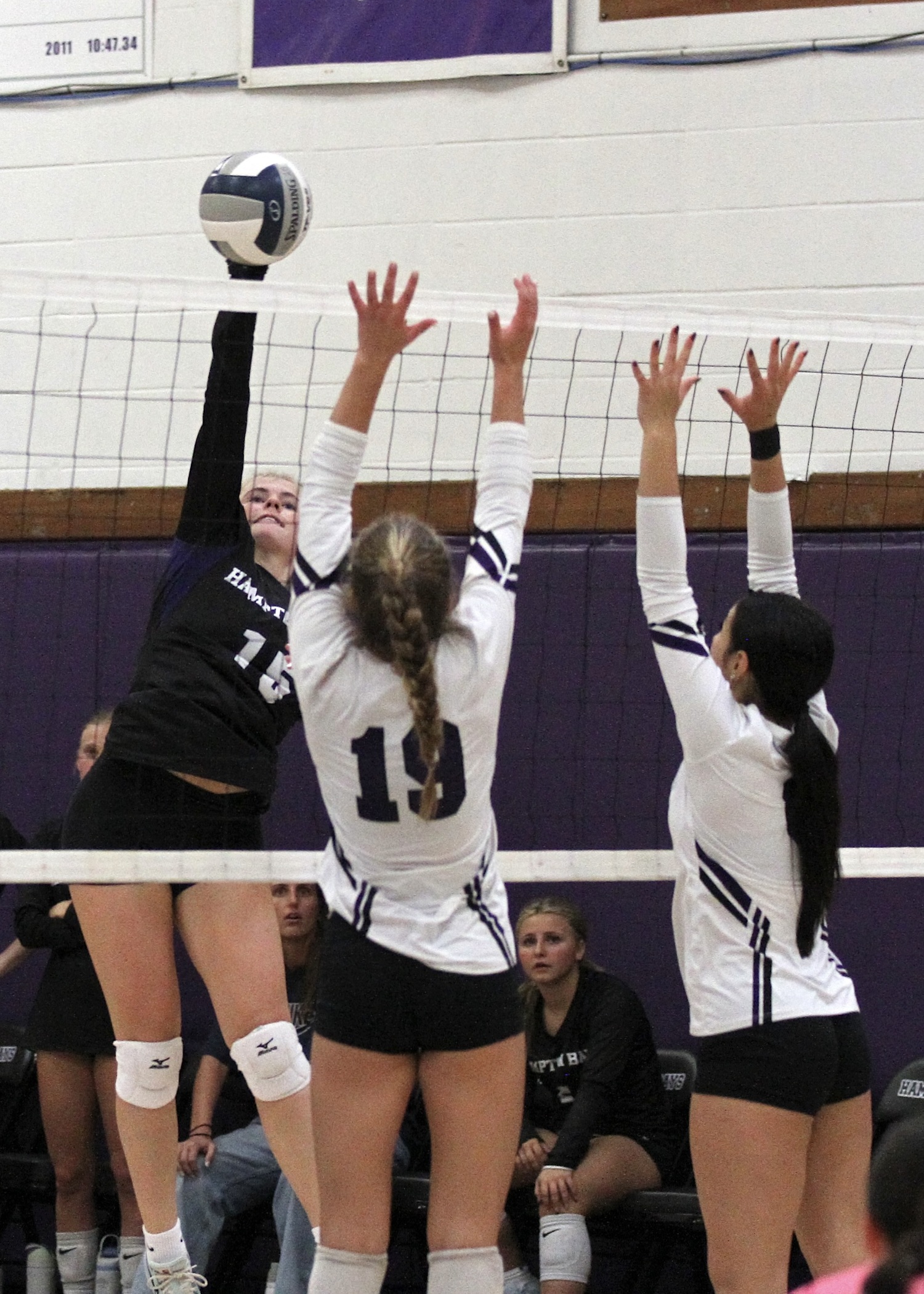 Senior outside hitter Taylor Meyers spikes the ball through blockers. DESIRÉE KEEGAN