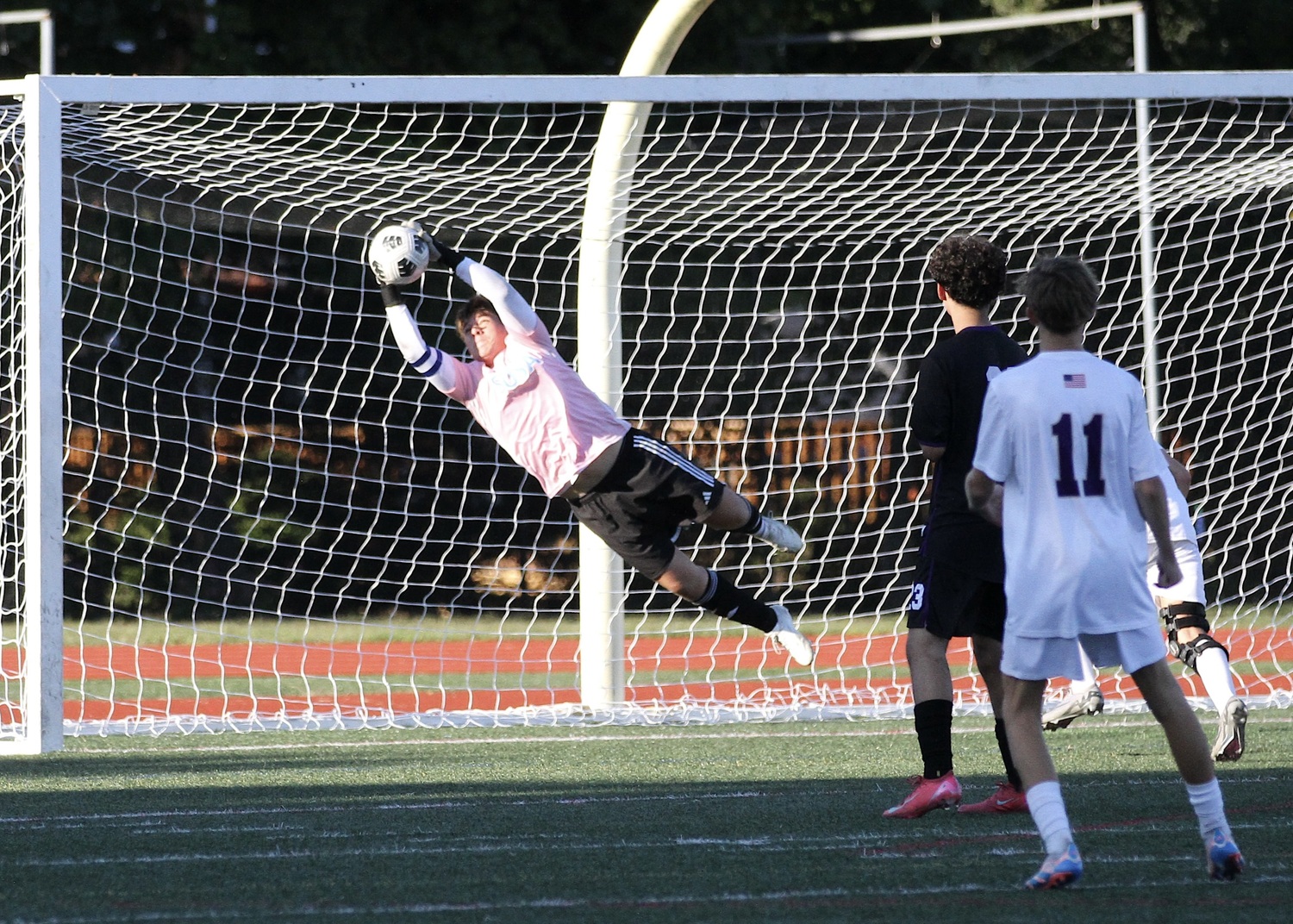 Senior goalkeeper Nick Osorio reaches for his one of seven stops against Sayville Thursday. DESIRÉE KEEGAN