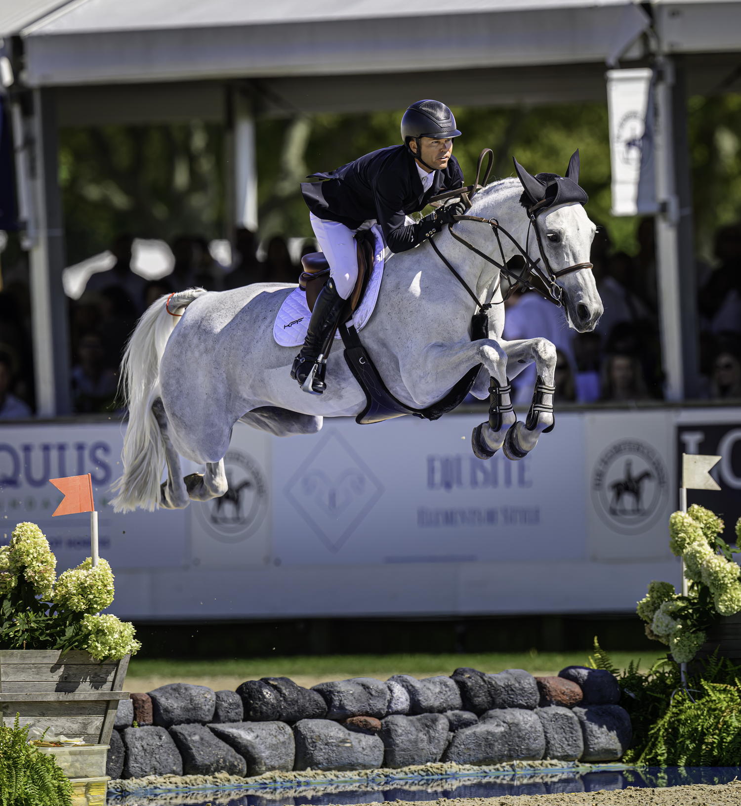 The world's top rider in Kent Farrington on Greya in perfect form over the water jump.  MARIANNE BARNETT