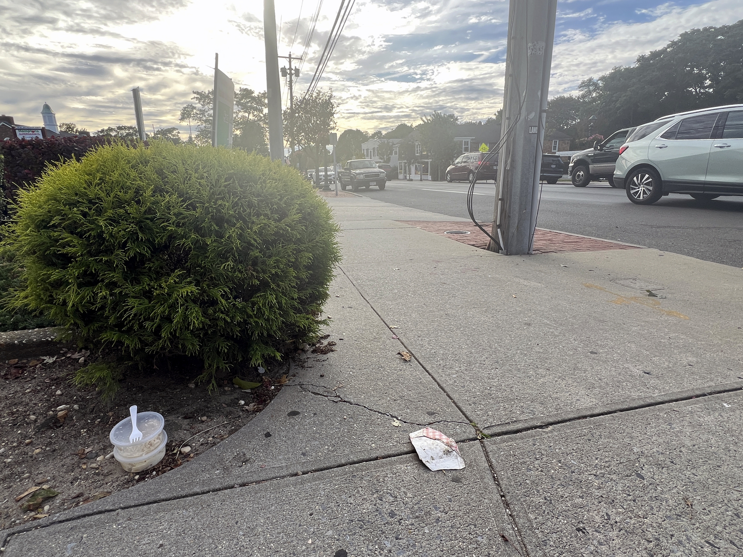 Trash cans are conspicuously missing from Main Street in Hampton Bays.  DANA SHAW