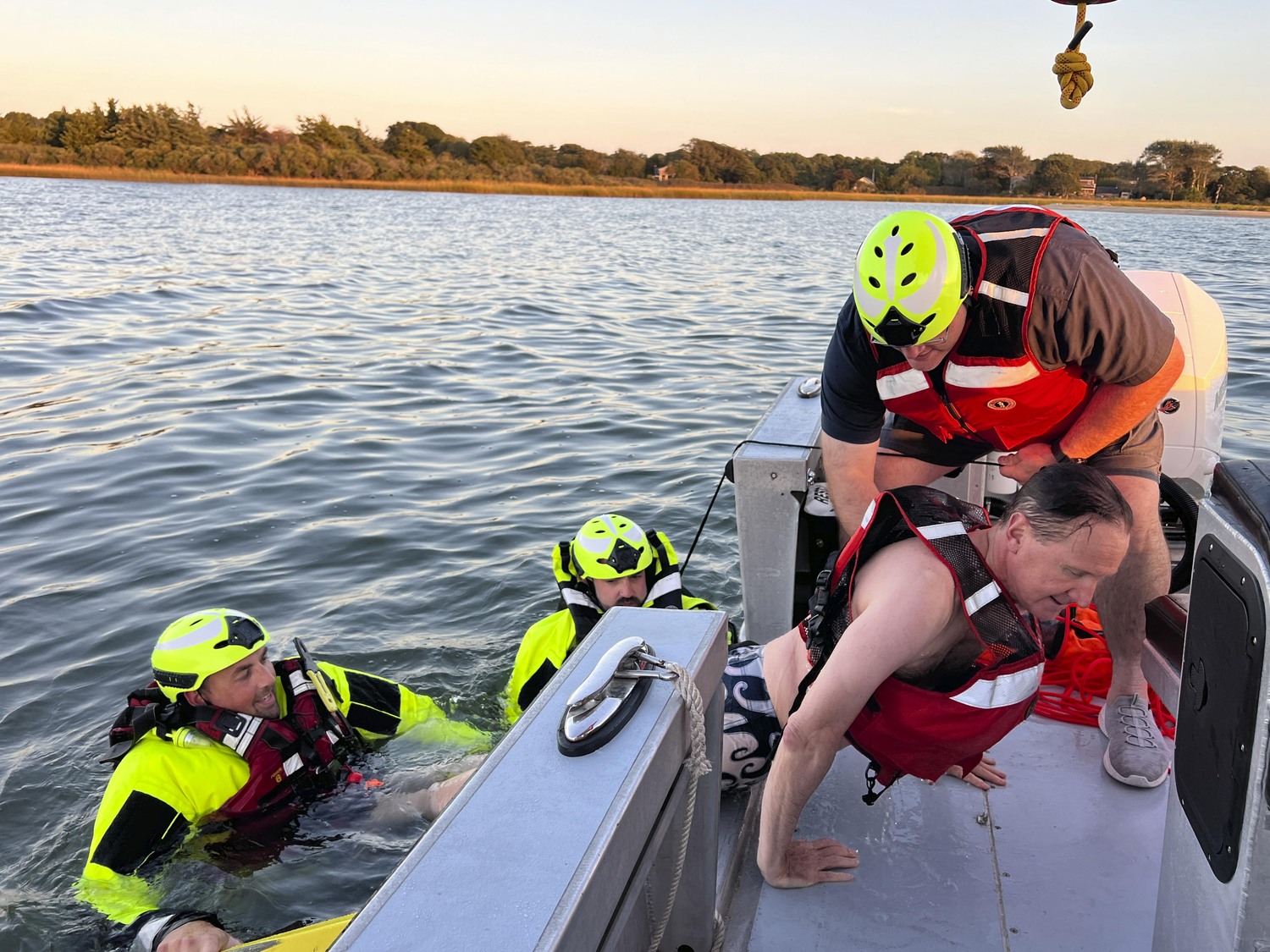 Southampton Village Mayor Bill Manger is brought aboard the boat while acting as a swimmer in distress at a drill on September 23.  DANA SHAW