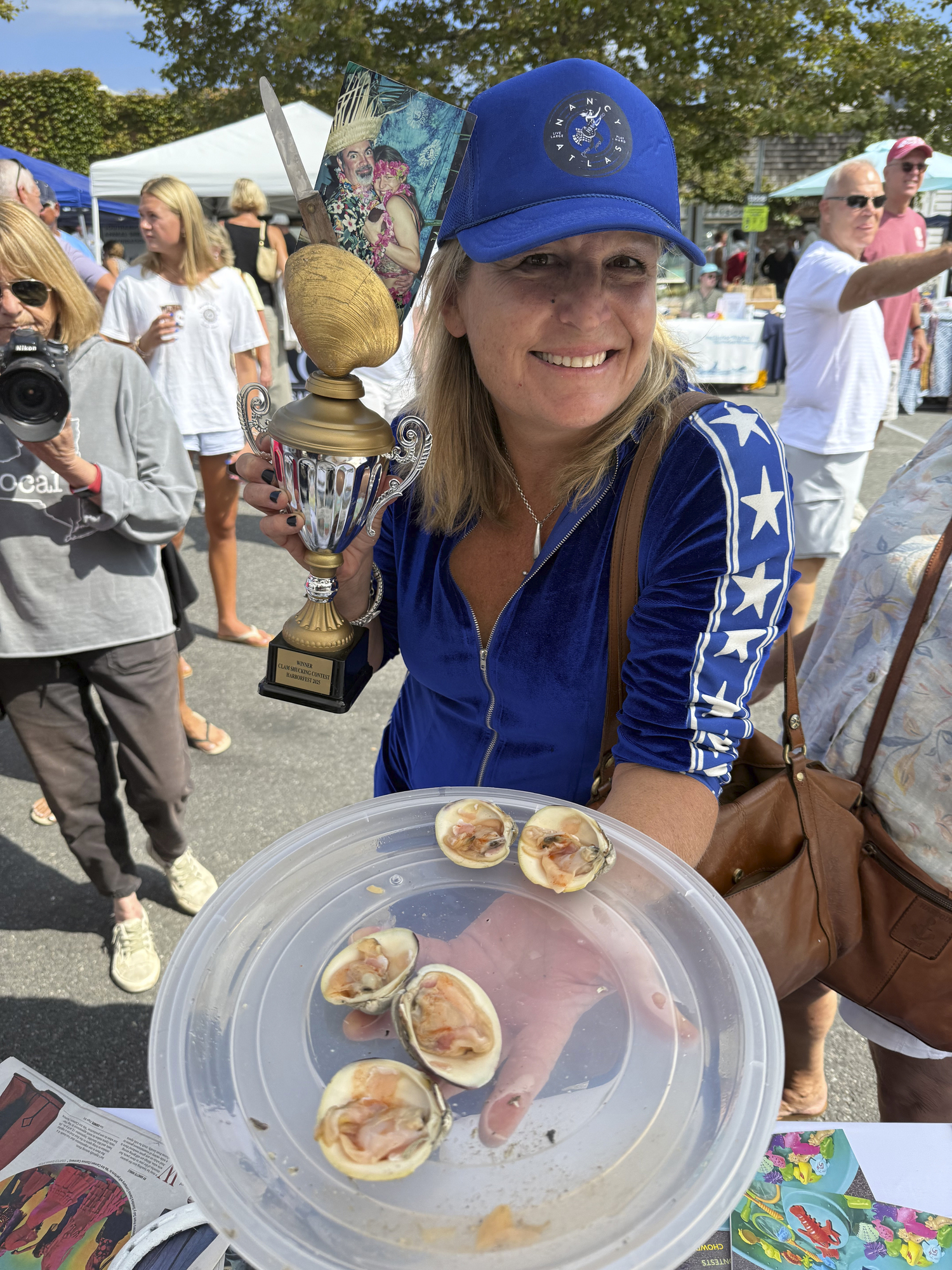 Nancy Atlas took the trophy in the clam shucking contest at HarborFest on Saturday.  GAVIN MENU