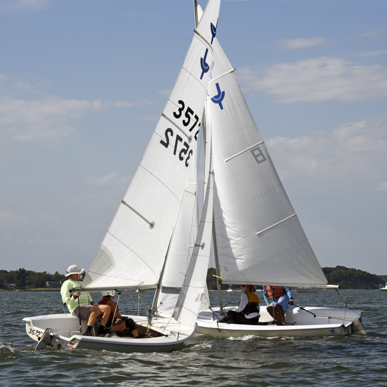 Near T-bone! Burdened port tack on left, with the second place team of Michael Bruynesteyn at the helm and Jennifer Krass “up-front,” about to slide by the stern of privileged starboard tack Lee Oldak and Sarah Alford.  MICHAEL MELLA