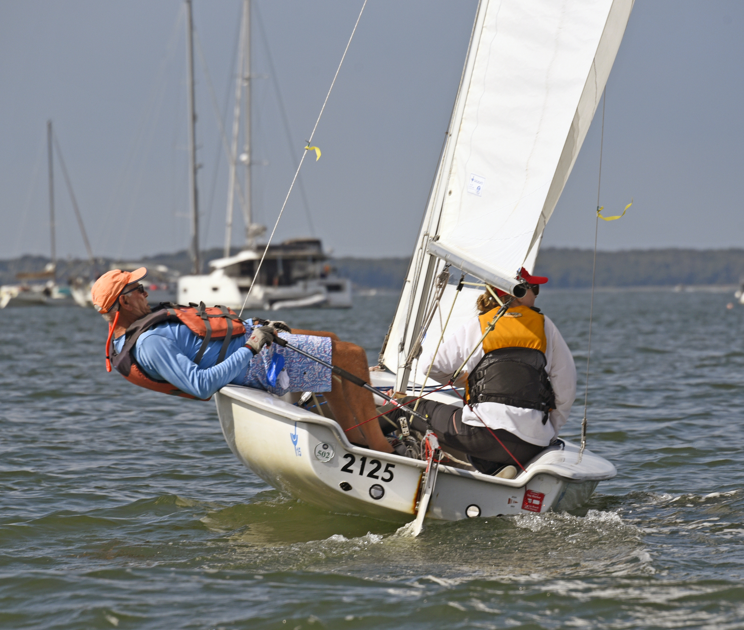 Lee Oldak showing the younger skippers his hiking-out talent as Sarah Alford scans the competition.  MICHAEL MELLA