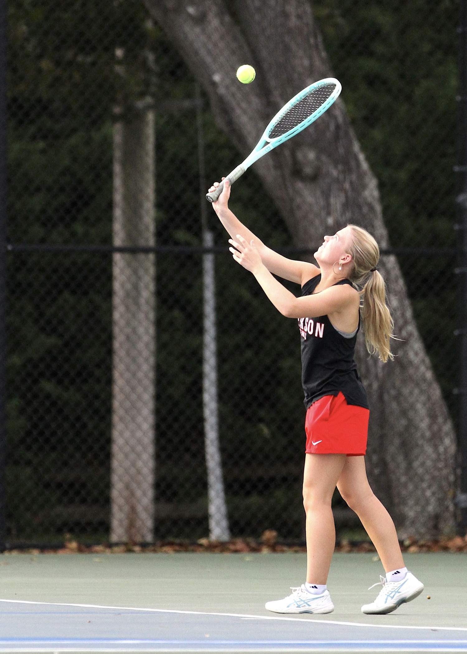 Senior Ally Cottrell serves. DESIRÉE KEEGAN
