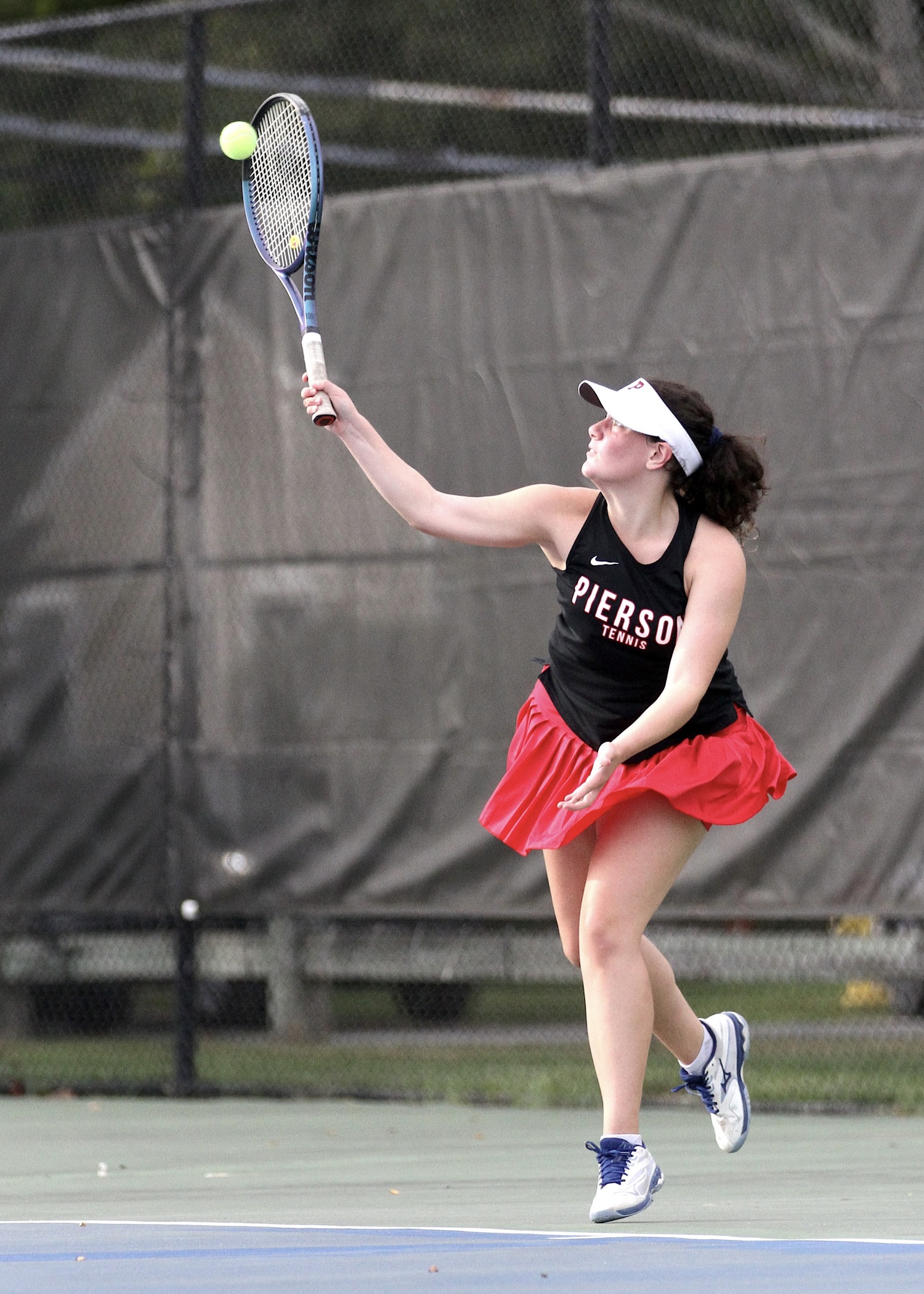 Eighth-grader Jade Glick serves. DESIRÉE KEEGAN
