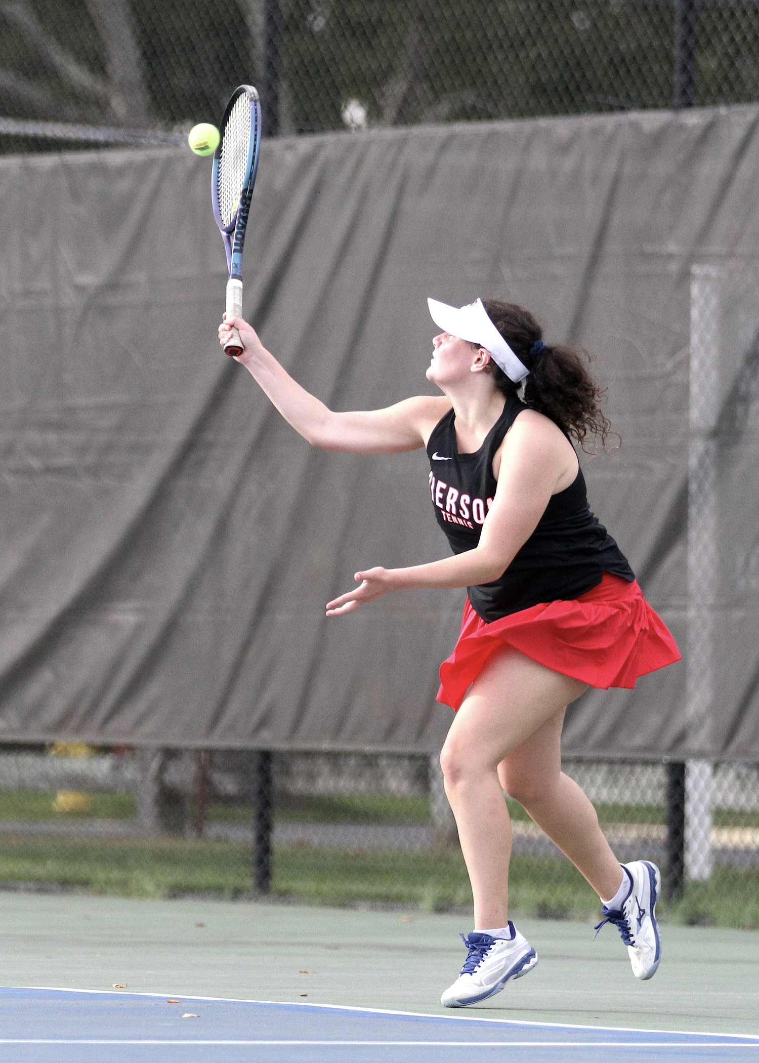 Eighth-grader Jade Glick serves. DESIRÉE KEEGAN