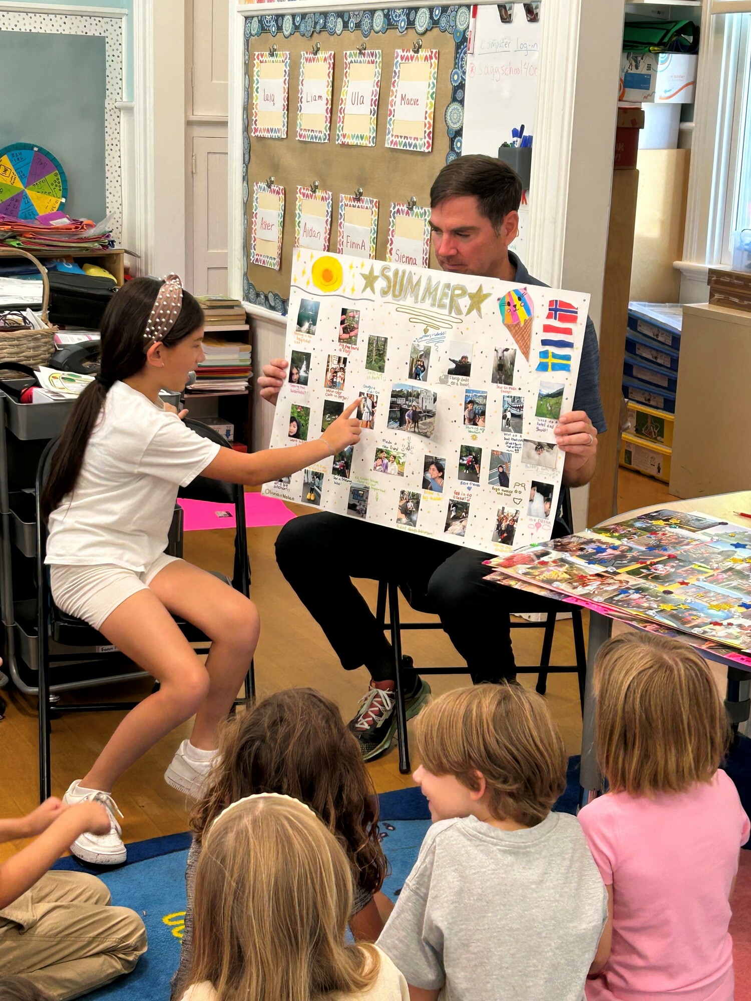 Sagaponack School third-grader Olivia Schwartz presented her poster depicting summer experiences and adventures, with help from teacher Terry Scammell. COURTESY SAGAPONACK SCHOOL
