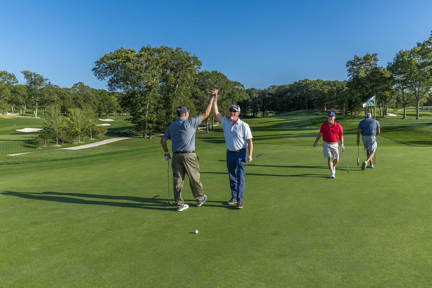 Ray Harden, in the red shirt, celebrated a great shot with his foursome at The Retreat’s Annual Golf Outing on September 22. Harden, co-owner of Ben Krupinski Builder, was the event’s honoree.  JIM LENNON
