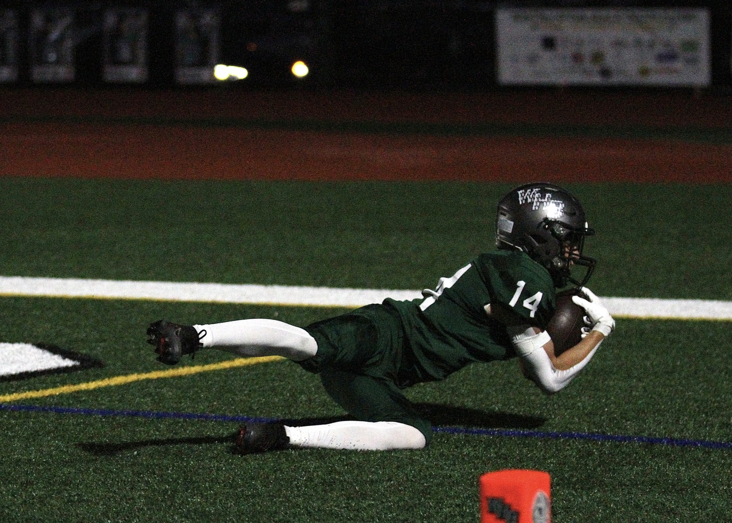Junior wide receiver Aiden Calamita lays out in the end zone for a touchdown. DESIRÉE KEEGAN