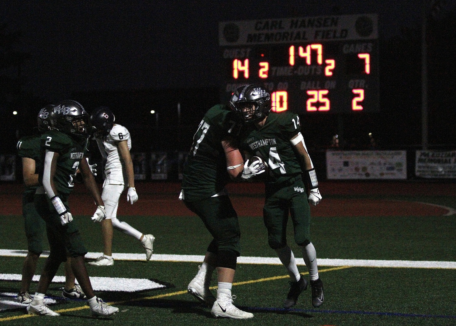 Senior lineman JP Peters and junior wide receiver Aiden Calamita celebrate Calamita's touchdown. DESIRÉE KEEGAN