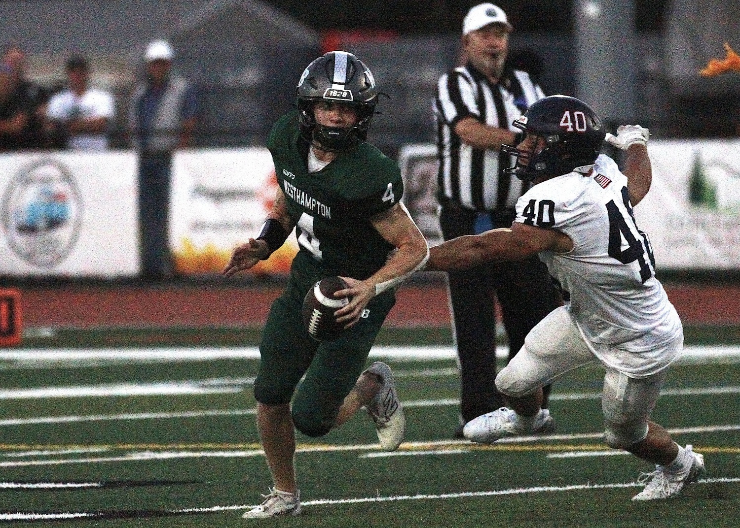 Junior quarterback Jake Calloway evades a tackle as he looks for the play. DESIRÉE KEEGAN