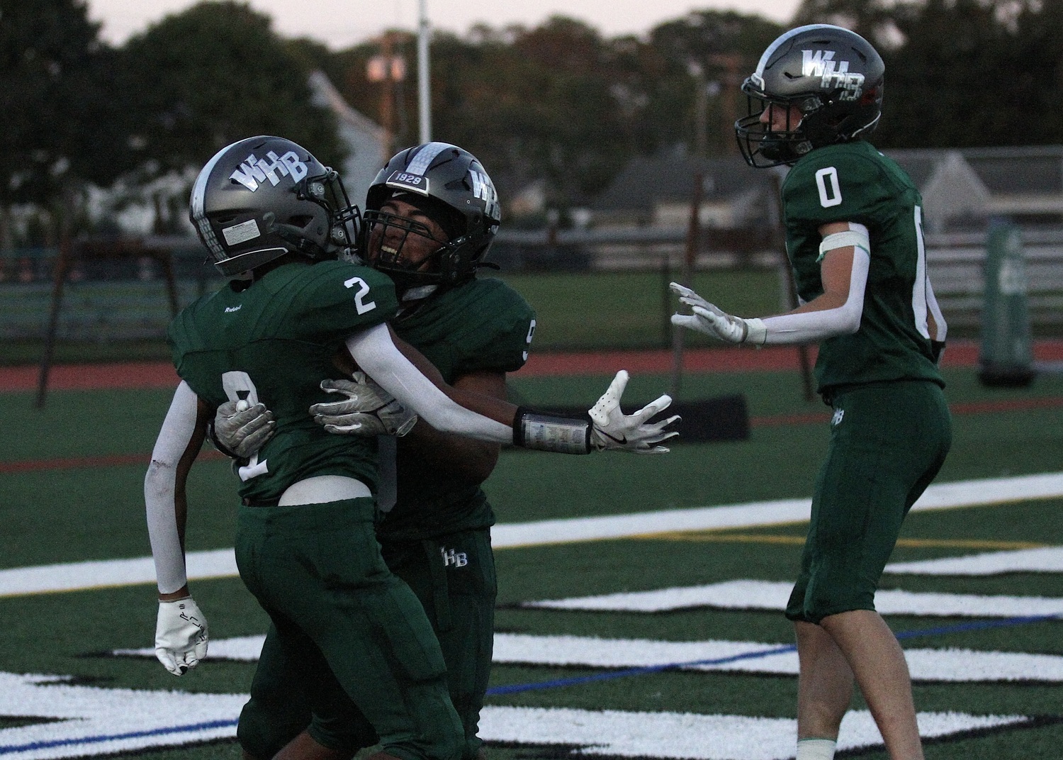 Junior wide receiver Kyle Coffey, junior running back Nic Simone and senior wide receiver Nate LoGelfo celebrate Coffey's touchdown. DESIRÉE KEEGAN