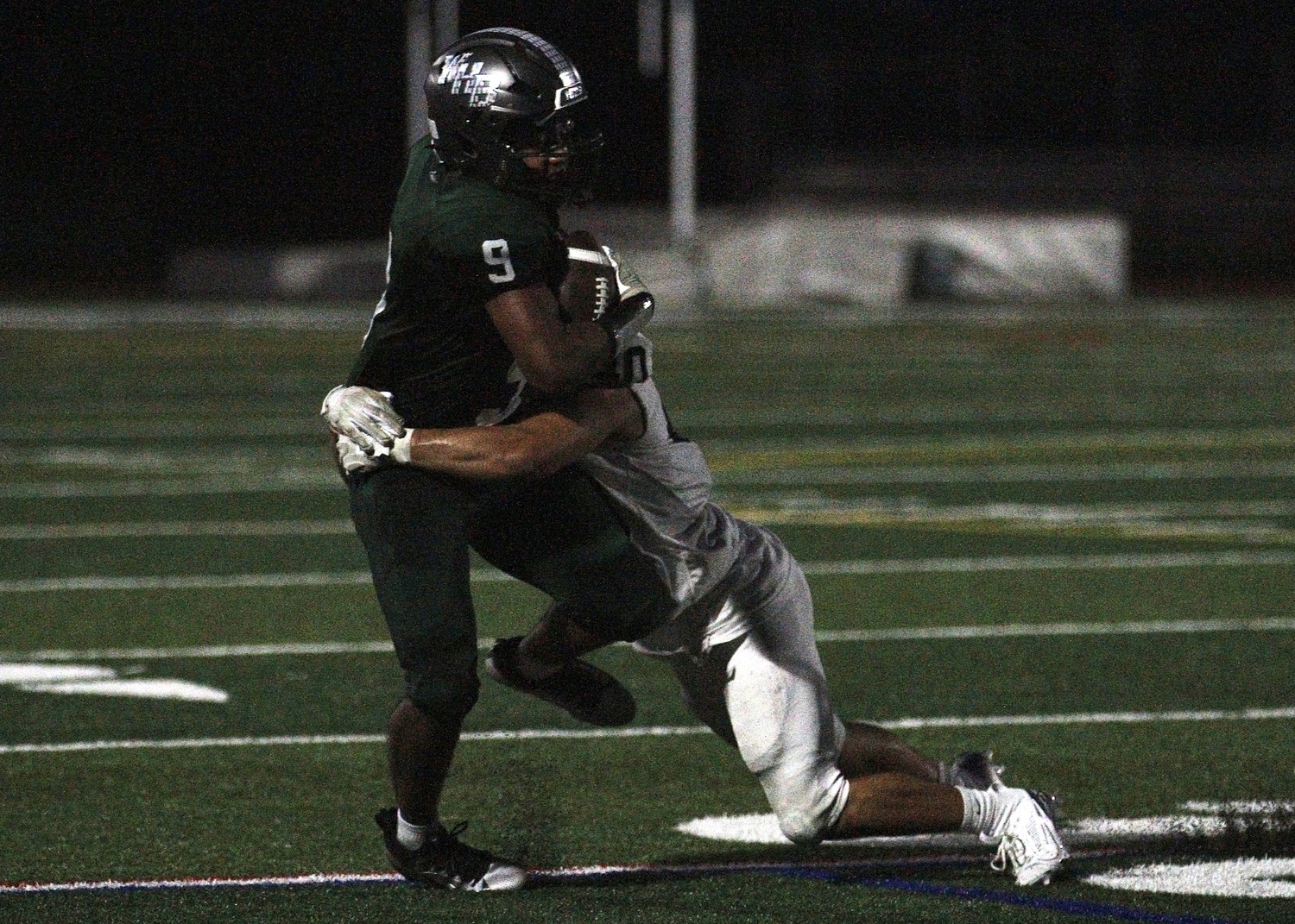 Junior running back Nic Simone rushes with the ball and a defender on his hip. DESIRÉE KEEGAN
