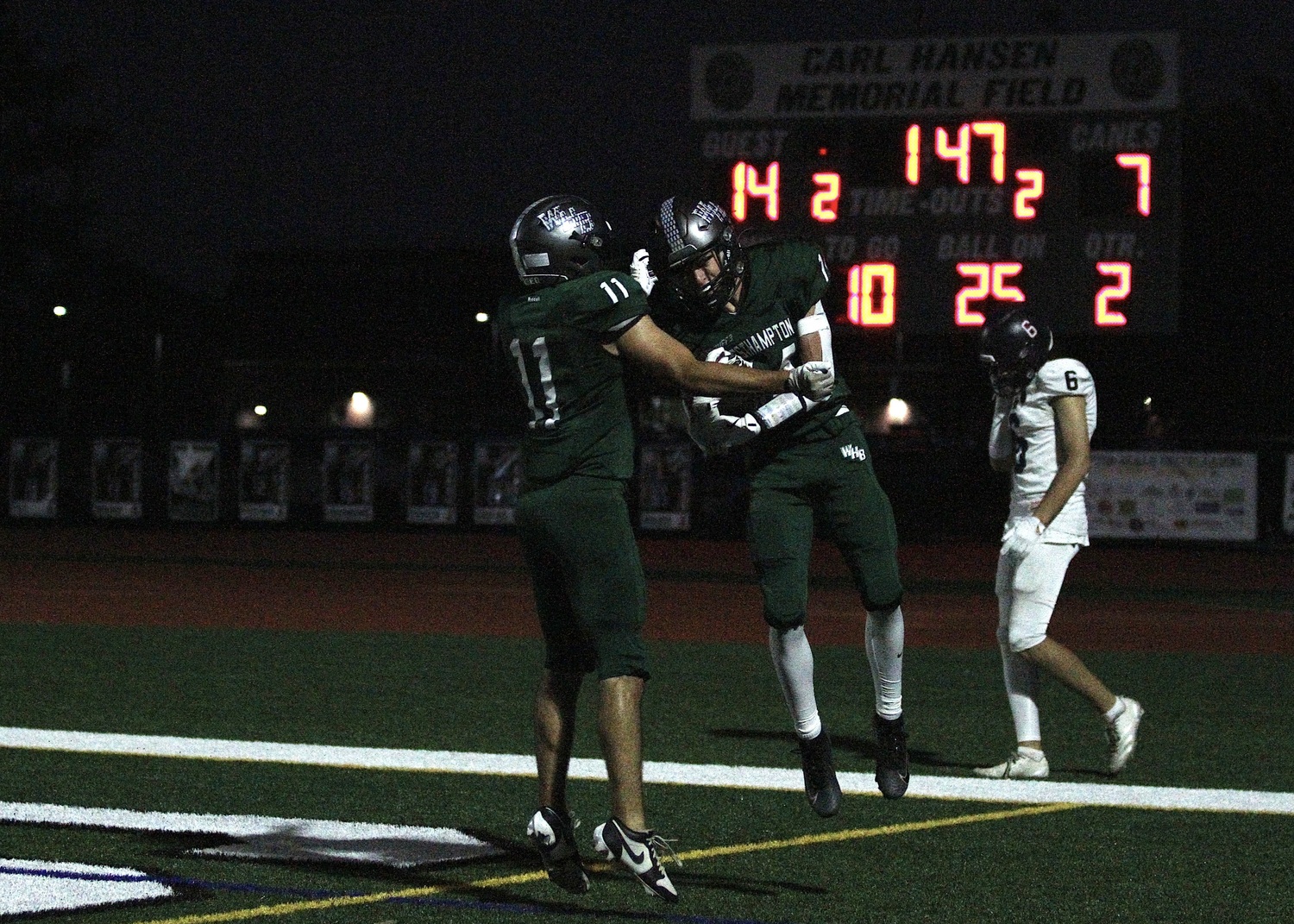 Senior wide receiver Riley Maire and junior wide receiver Aiden Calamita celebrate Calamita's touchdown. DESIRÉE KEEGAN