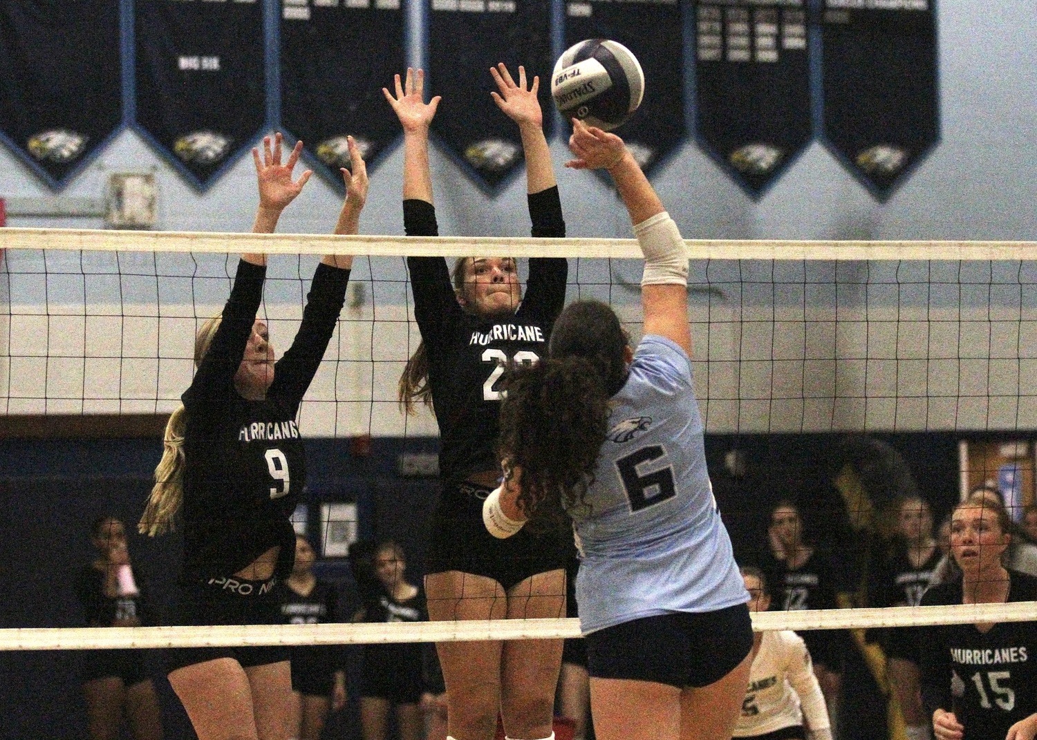Senior opposite hitter Lauren Glynn and sophomore middle blocker Reilly Maloney reach for the ball.