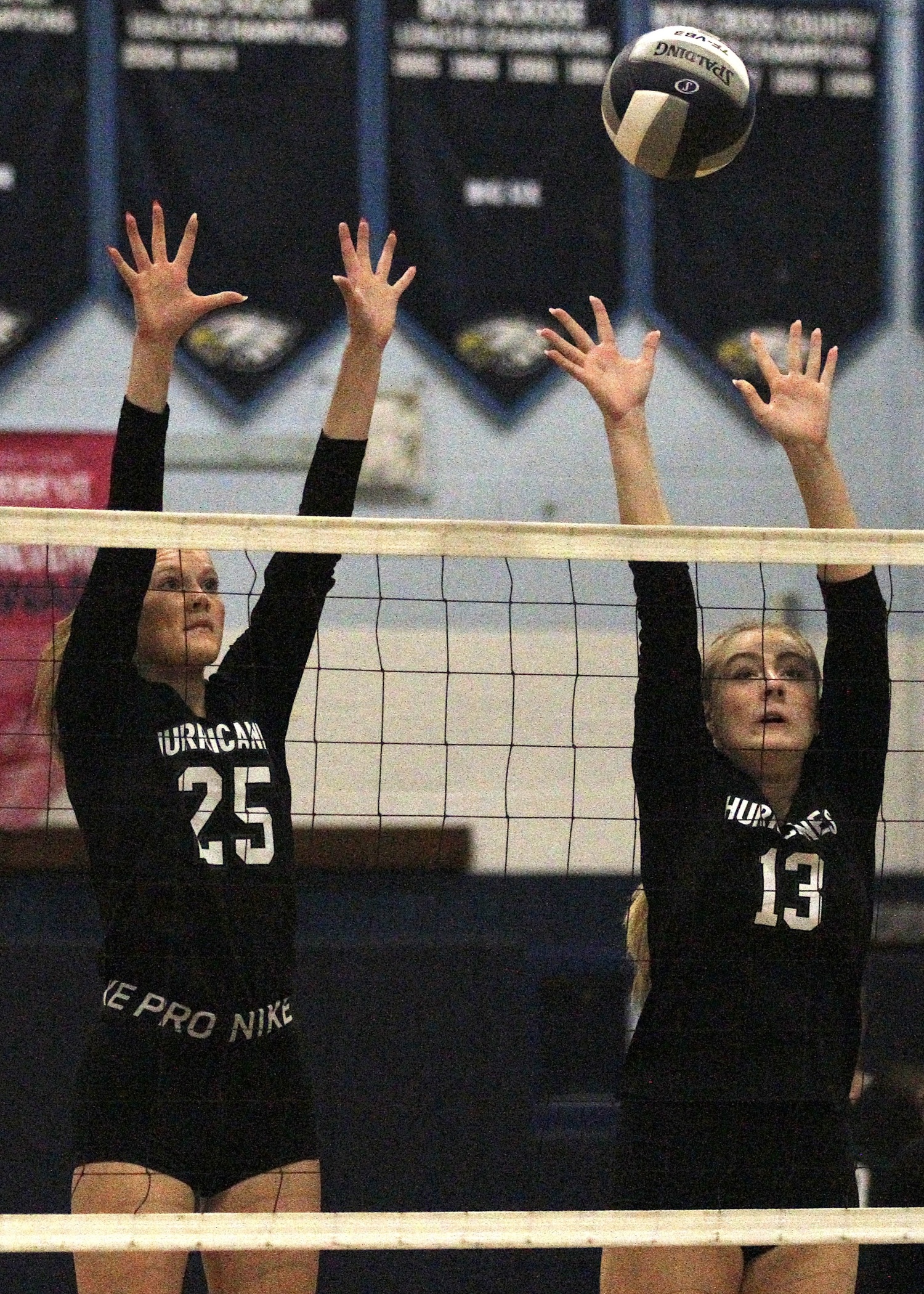 Senior right side Mia Hill and middle hitter Laine Kwiatkowski reach for a block. DESIRÉE KEEGAN