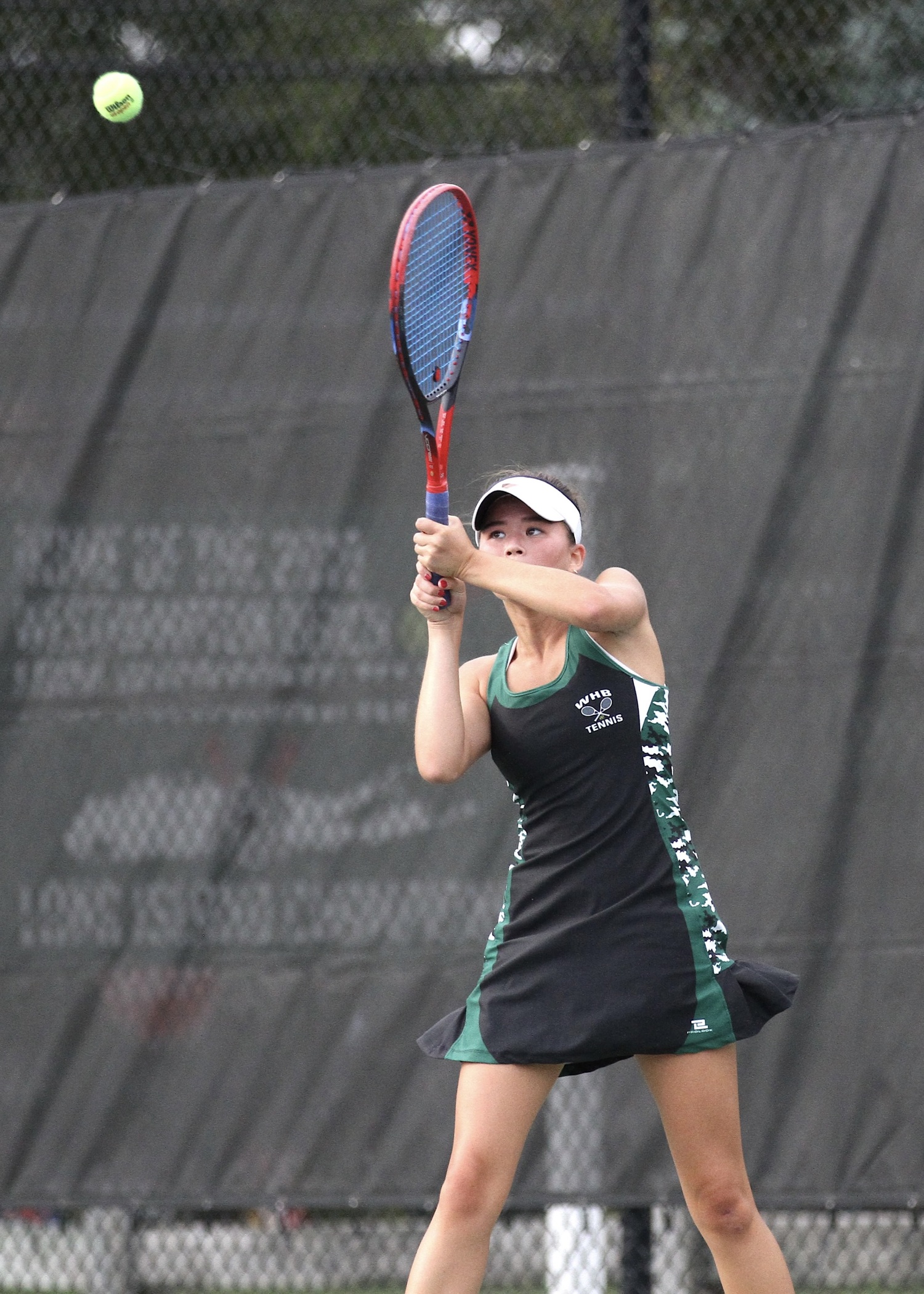 Senior Diana Elliott powers the ball back over the net. DESIRÉE KEEGAN