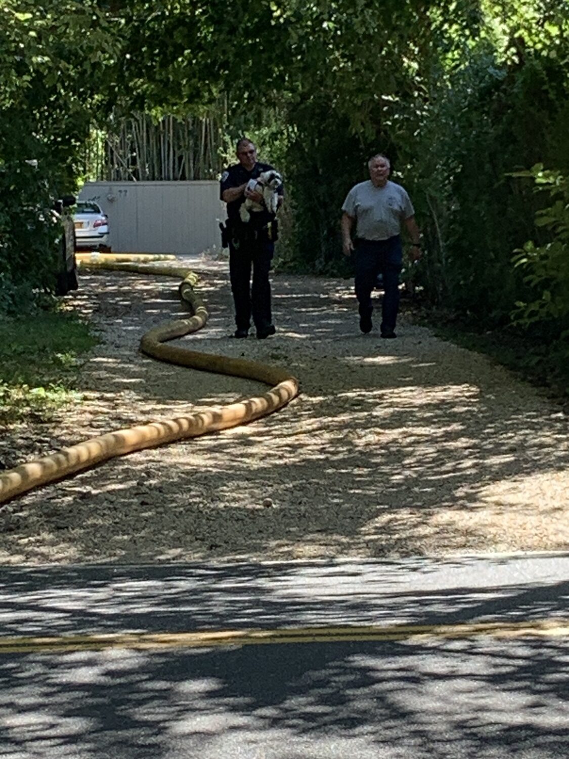 A Southampton Town police officer emerged from the fire scene with a small dog in his arms. STEPHEN J. KOTZ
