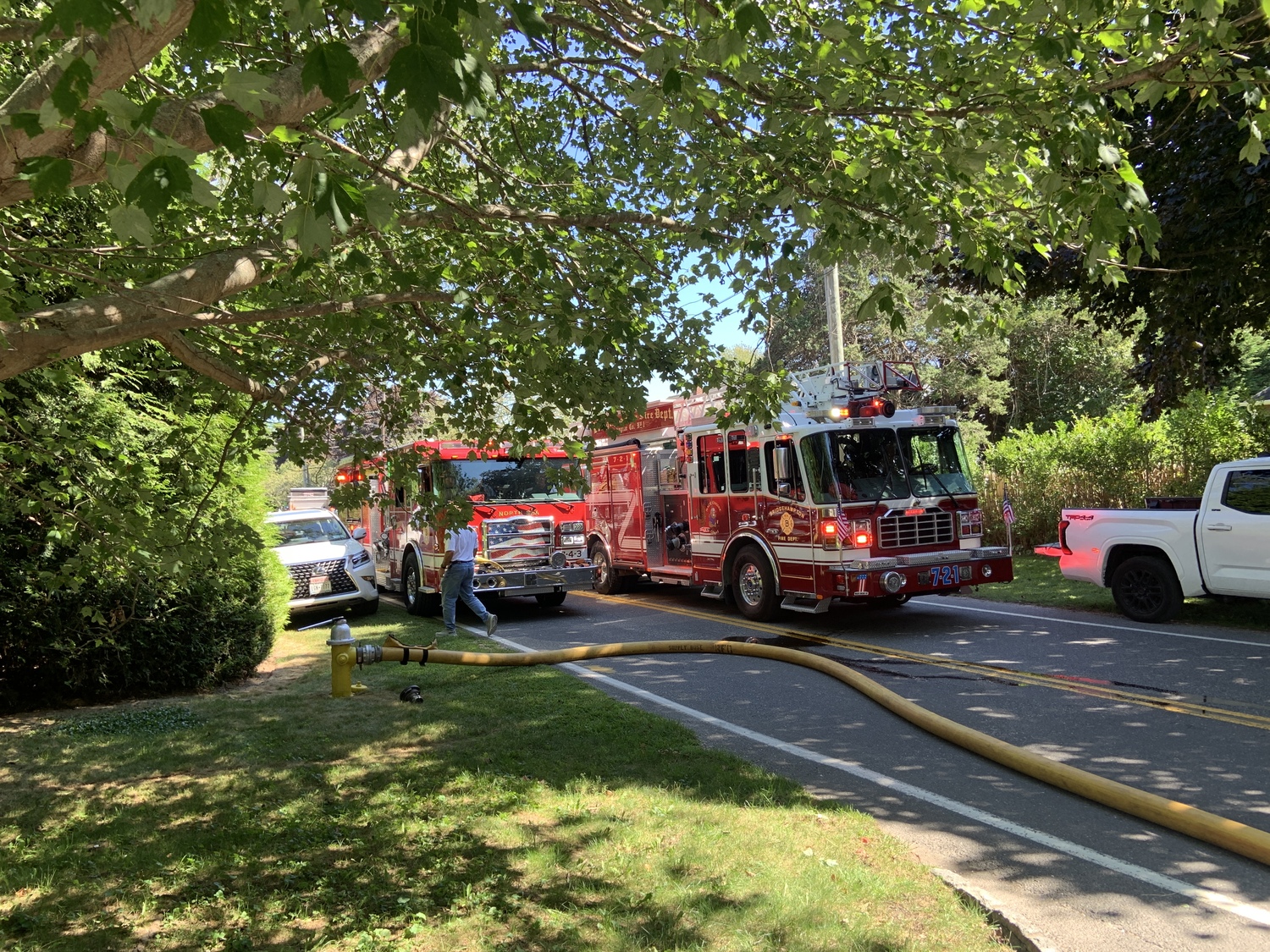 A Bridgehampton Fire Department ladder truck and pumper at the scene of a house fire on Hildreth Lane Friday afternoon. STEPHEN J. KOTZ