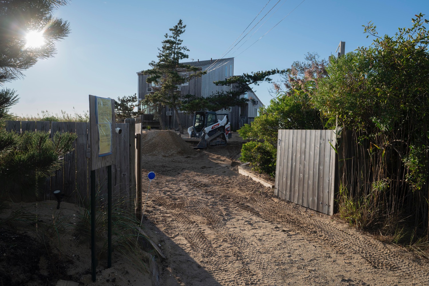 The East Hampton Town Building Department signed off on the installation of new GeoCubes following several lawsuits. A building permit is visible on the property of one of the residences that has been protected by the cubes since 2018. DOUG KUNTZ