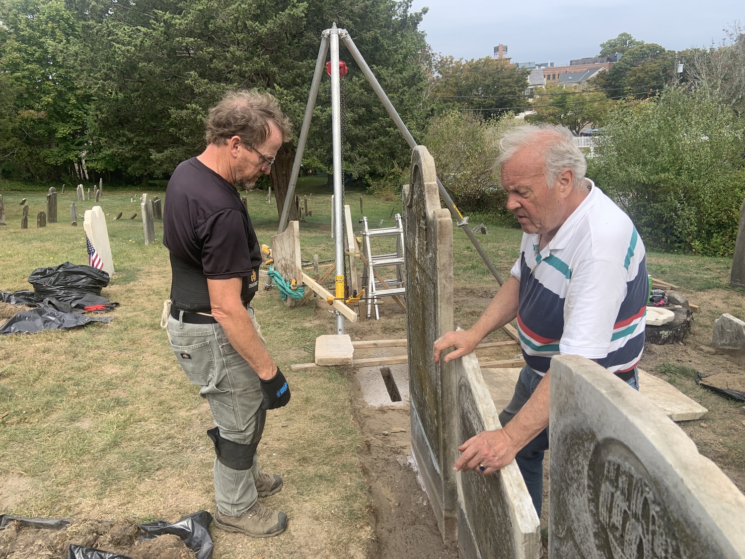 Joel Snodgrass, left, and Zach Studenroth resetting Beebee family headstones in the Old Burying Ground next to the First Presbyterian (Old Whalers) Church of Sag Harbor. STEPHEN J. KOTZ