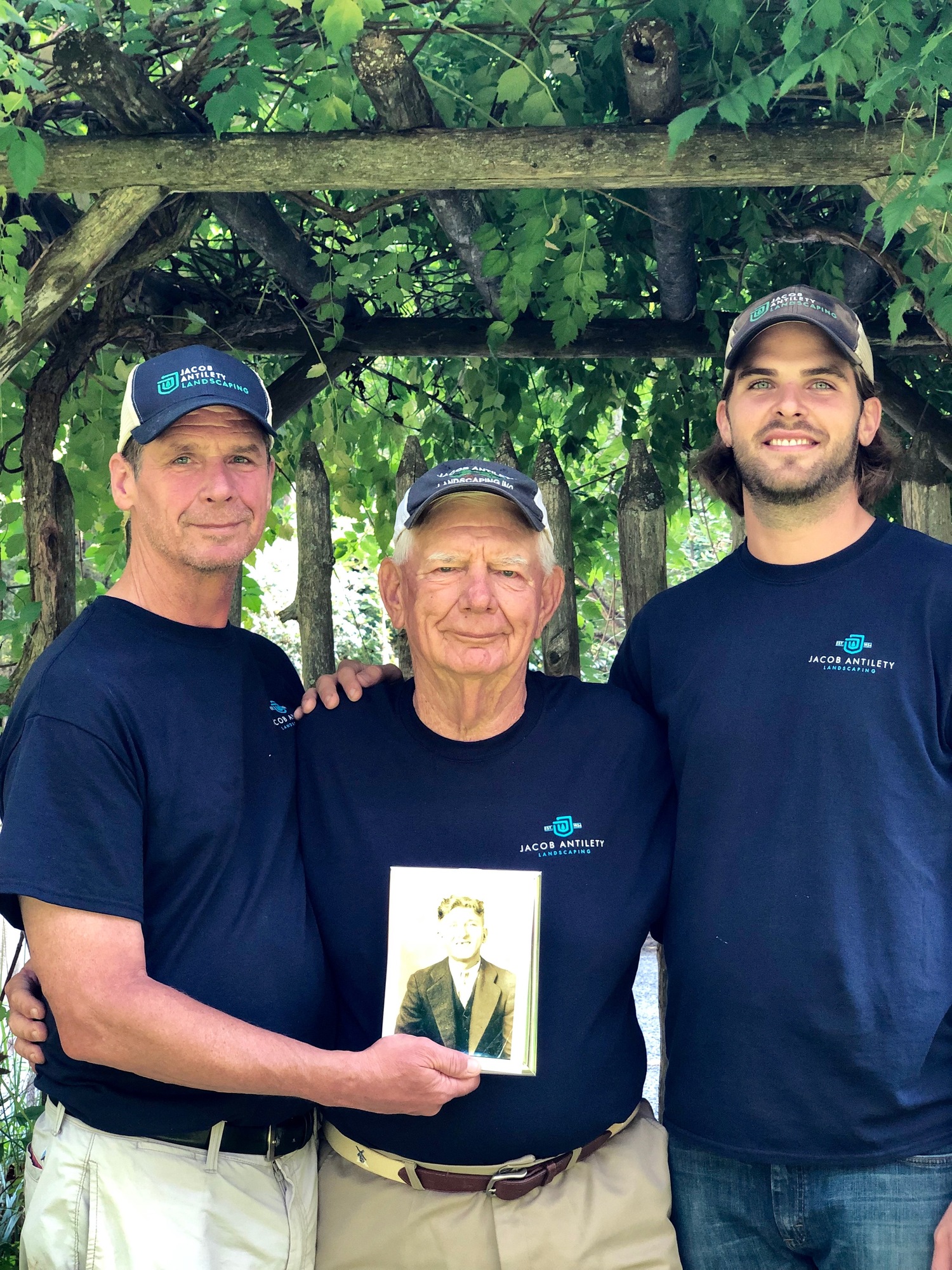 Mark, Bill and Alex Antilety, with a photo of Jacob Antilety. COURTESY MARK ANTILETY