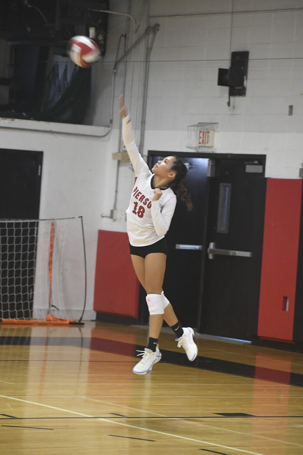 Junior C.J. Echavarria serves.  DREW BUDD